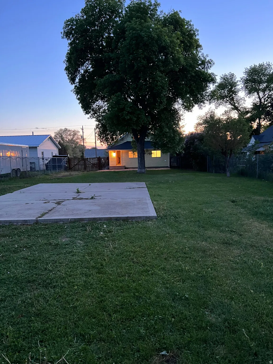 Fresh cut grass and the setting sun.  A glimpse as to what you could enjoy in this lovely back yard setting.