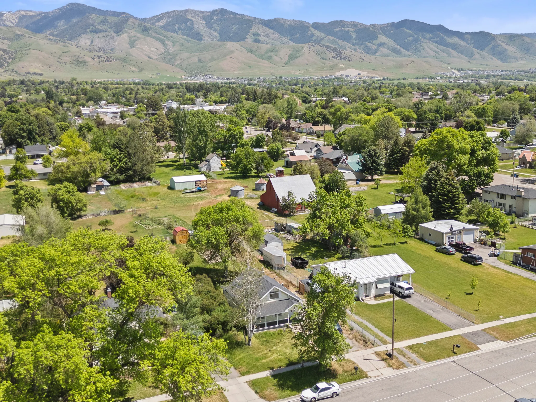 Mountain backdrop framing a residential area with residential homes, mature trees. Two blocks from the Library, skate park and city amenities.