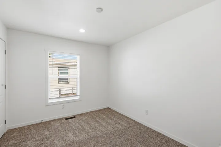 Neutral tone carpeting complements white walls and trim