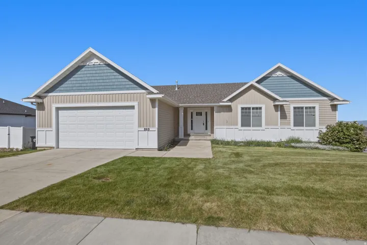 Ranch-style residence featuring a two-tone facade with tan horizontal siding and blue-gray shingle accents