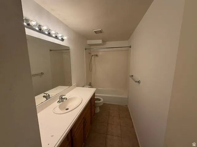 Bathroom featuring a spacious vanity with an integrated sink, polished chrome faucet, and wood-finish cabinetry