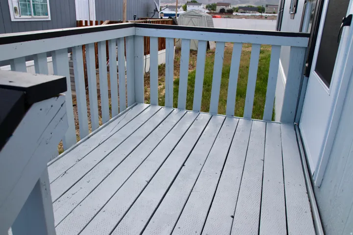 Wood deck with painted finish and railing