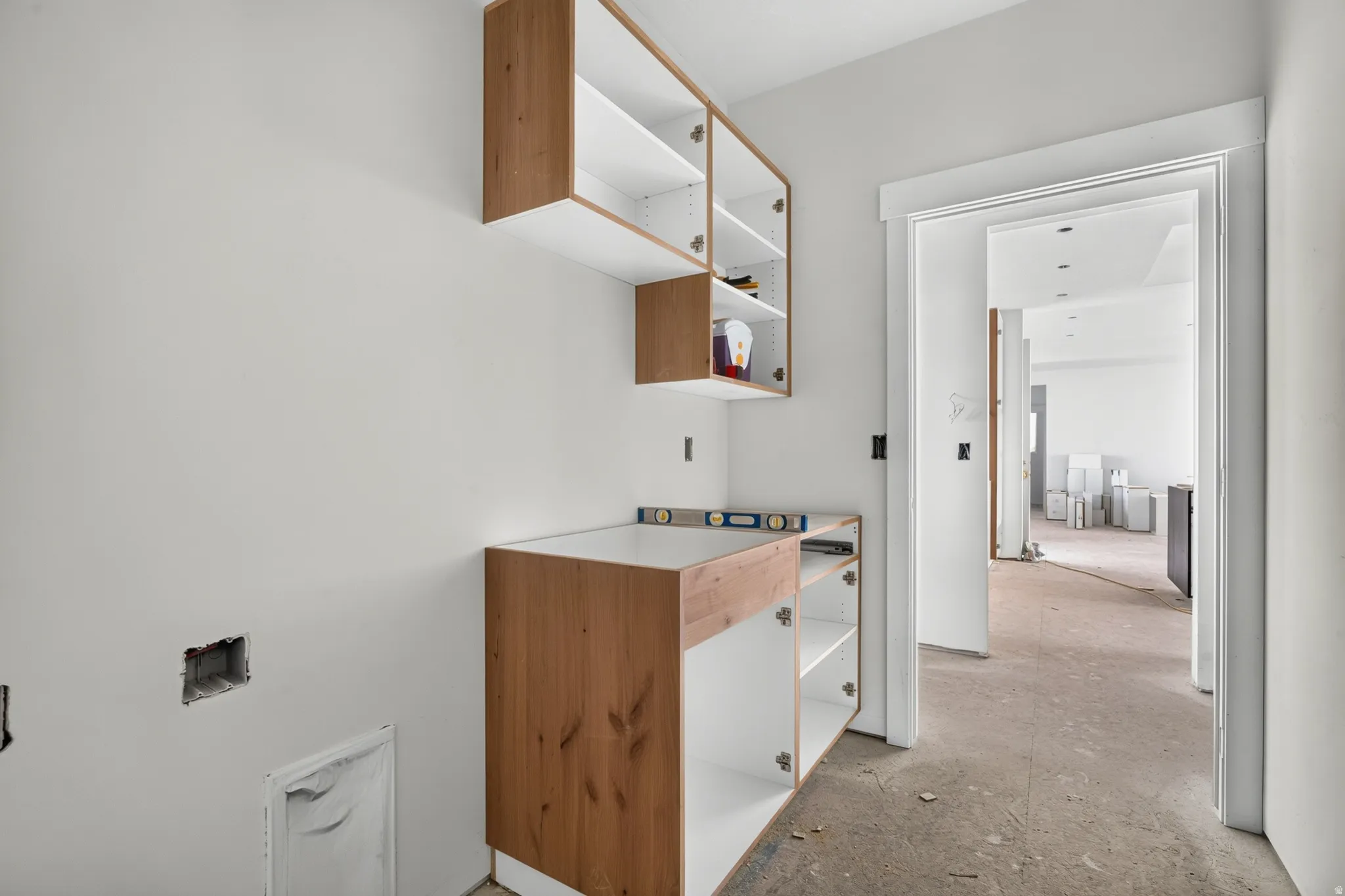 New construction featuring white walls, wood-finish cabinetry, and an open doorway