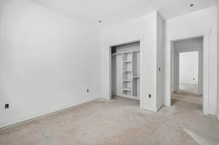 Recessed lighting, built-in closet shelving, and multiple doorway entries