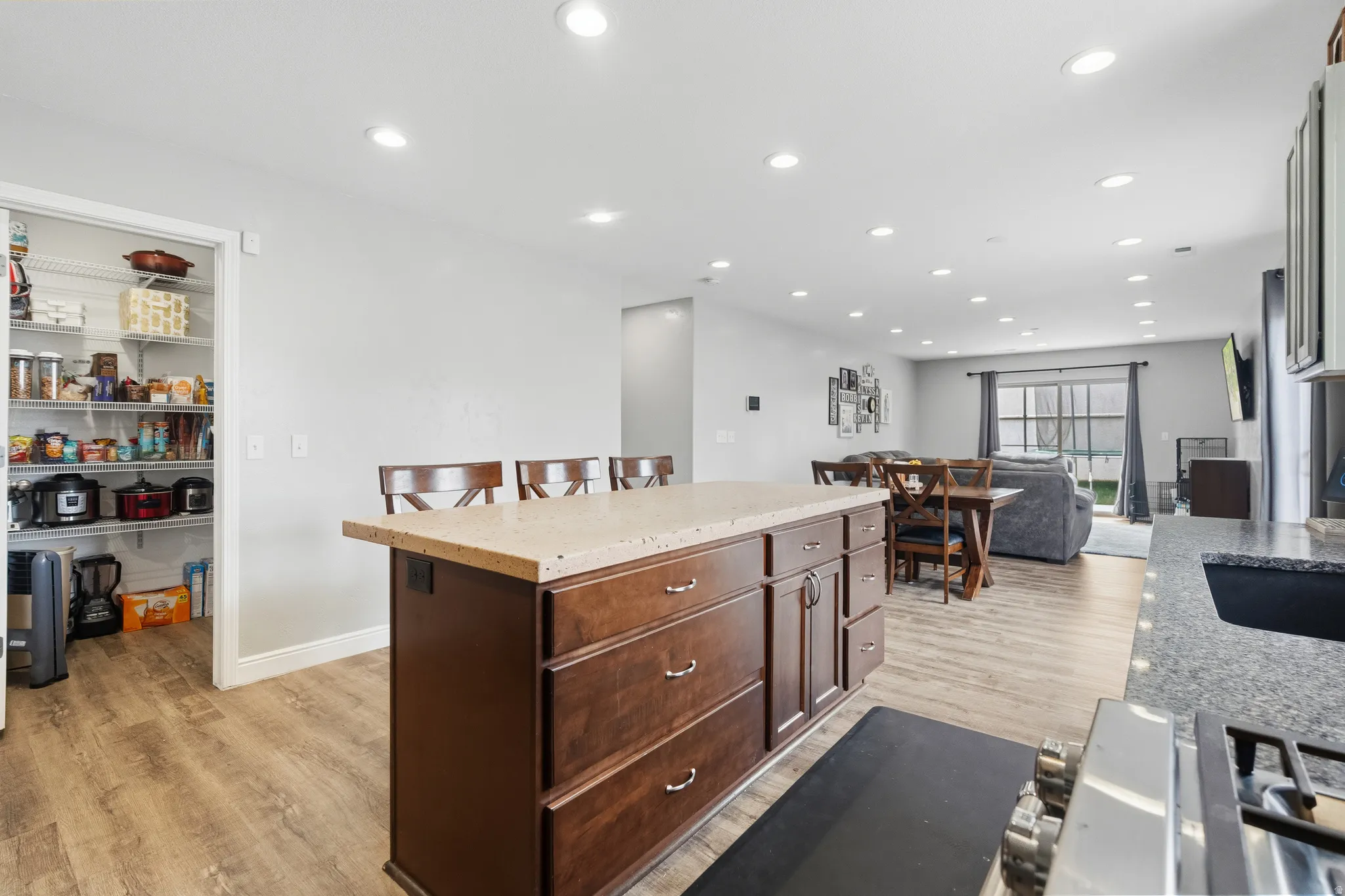 Kitchen island with a light-toned countertop and wood-finish cabinetry