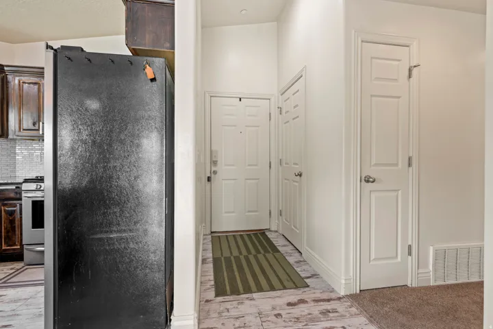 Bright entryway featuring light wood-finish flooring and a neutral color palette