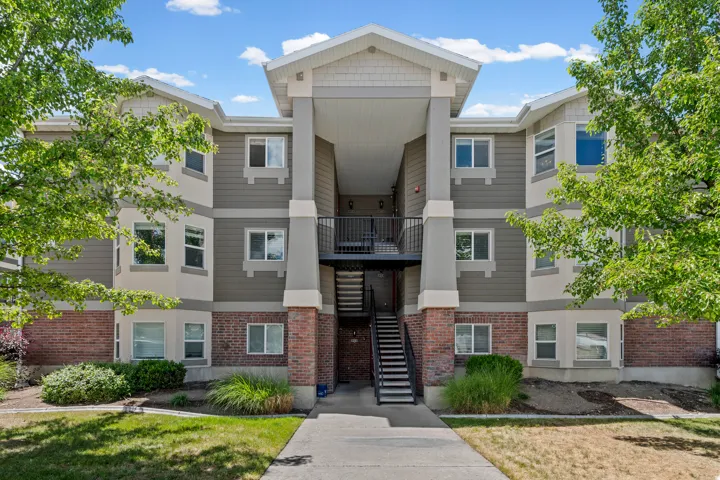 Multi-story building featuring a brick base with siding and shake accents