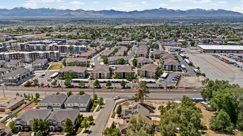 Expansive aerial perspective showcasing a residential community with multi-story apartment buildings and single-family residences
