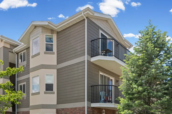 Multi-story exterior with horizontal siding and brick accents