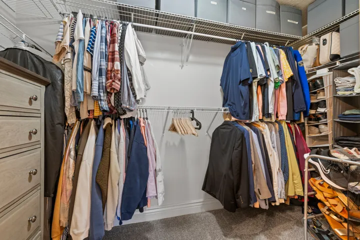 Custom closet system featuring wire shelving and multiple hanging rods for optimized organization