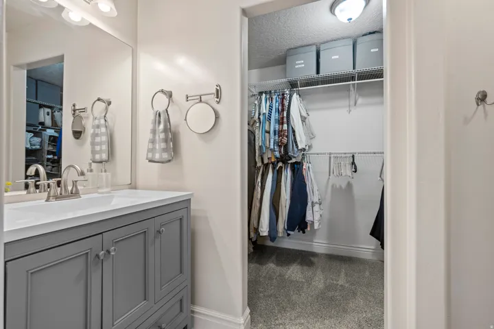 Bathroom vanity with a gray cabinet base and white countertop