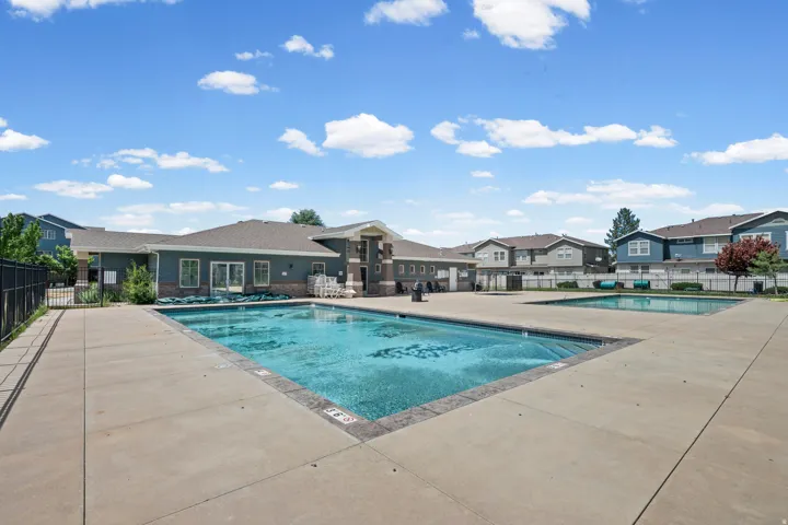Community swimming pool with concrete decking