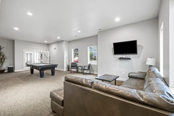 Spacious common area featuring light gray walls and recessed lighting