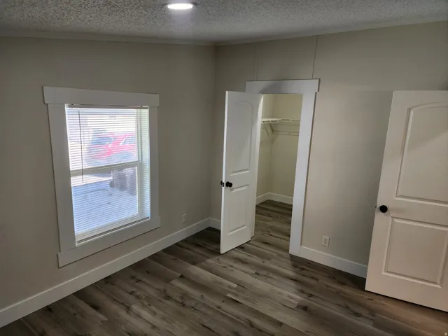 Neutral wall color complemented by wood-finish flooring