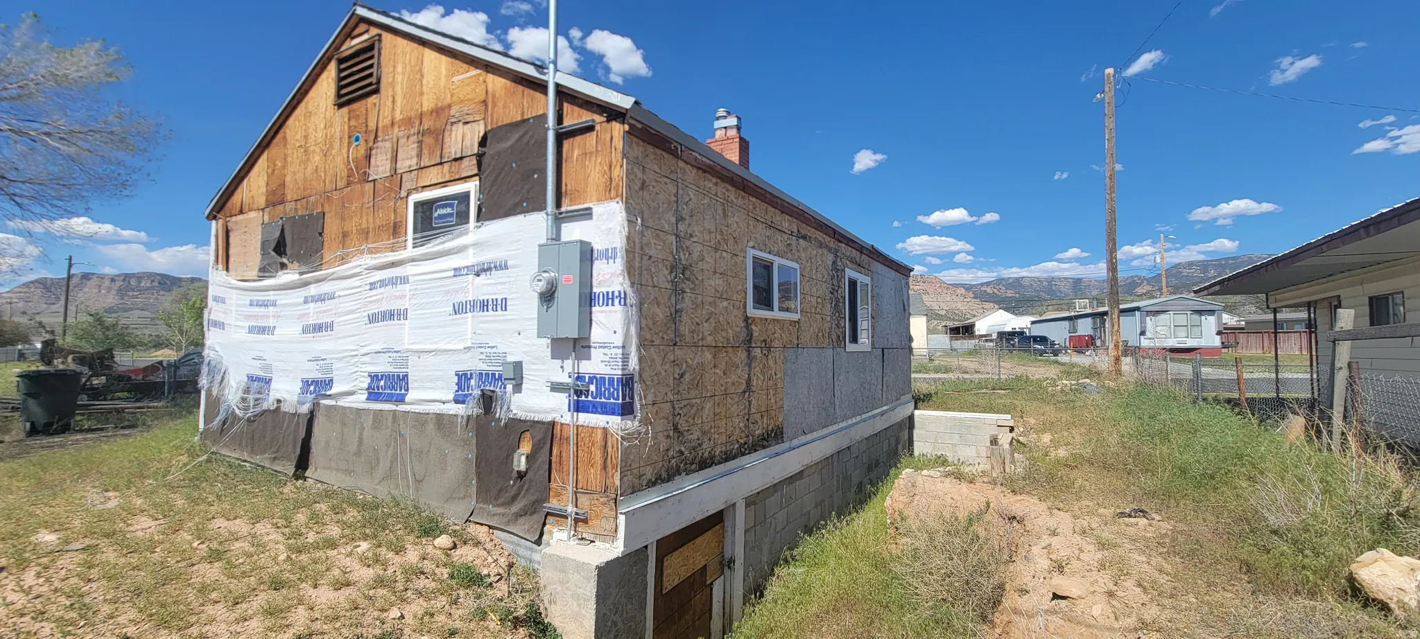 Property exterior featuring exposed wood siding and OSB sheathing