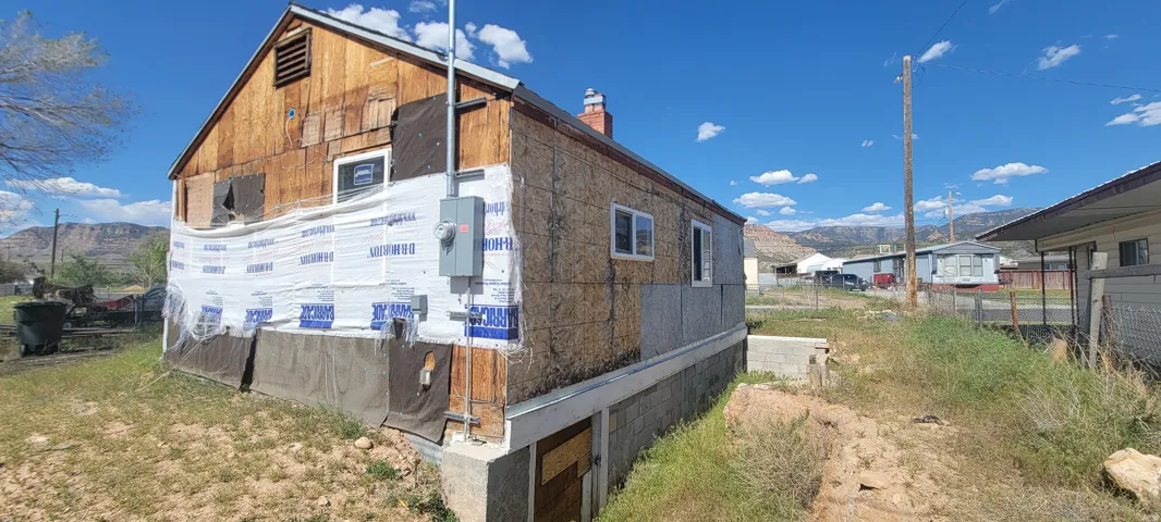 Property exterior featuring exposed wood siding and OSB sheathing
