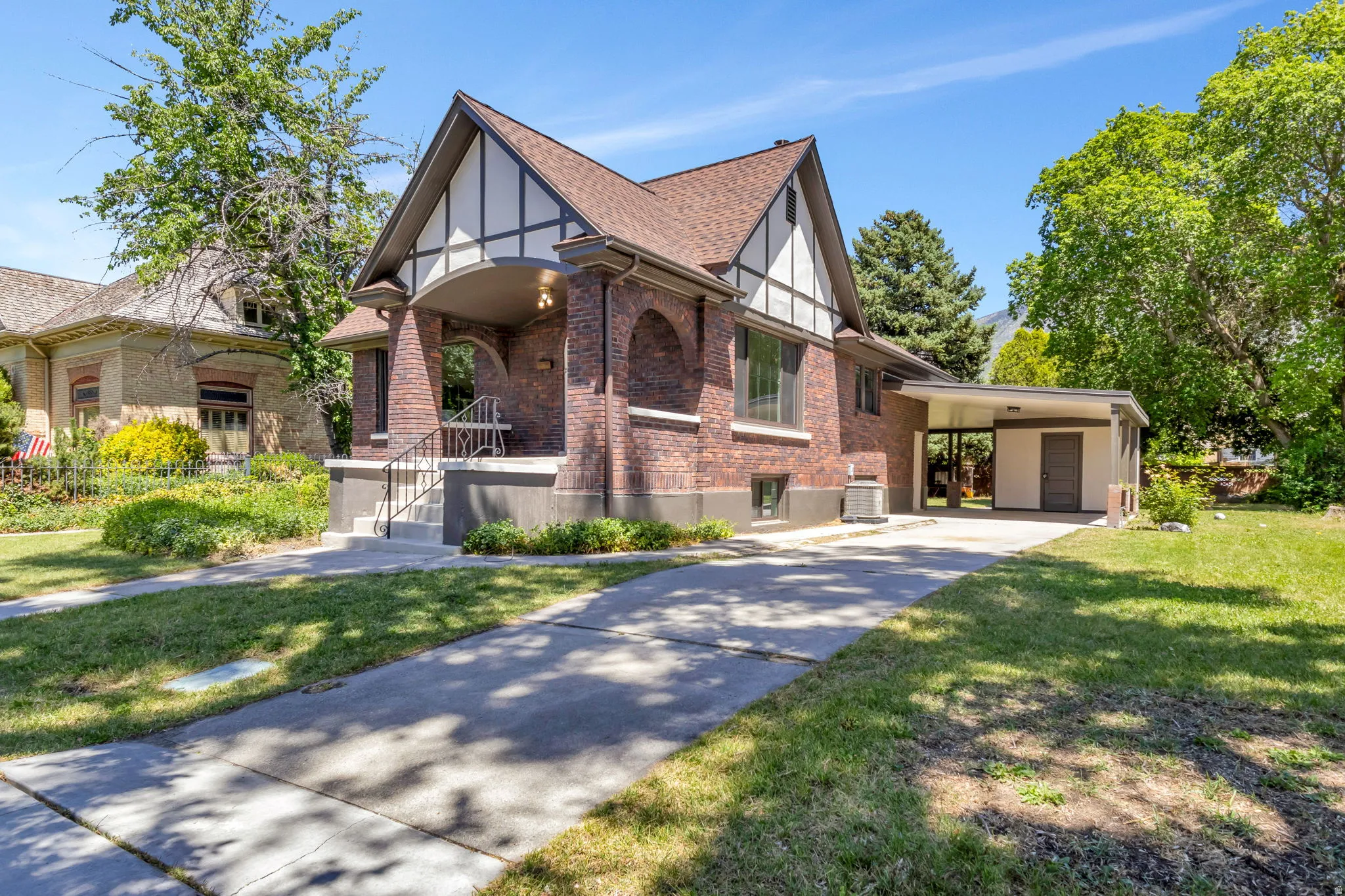 Brick home with Tudor-style gables and a covered front entry porch
