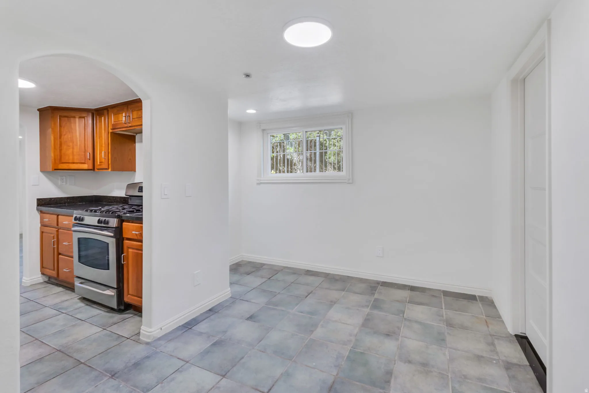 Room featuring slate-look floor tiles and bright white walls