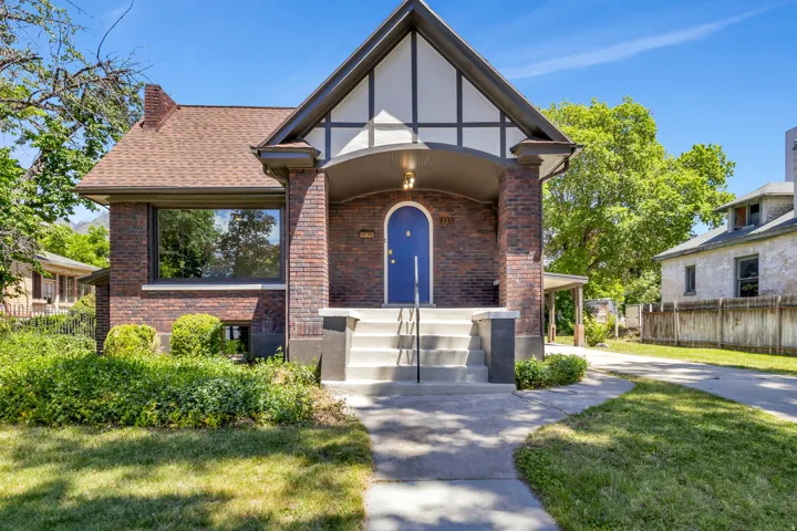 Brick Tudor-style residence featuring a prominent gabled roofline with decorative half-timbering