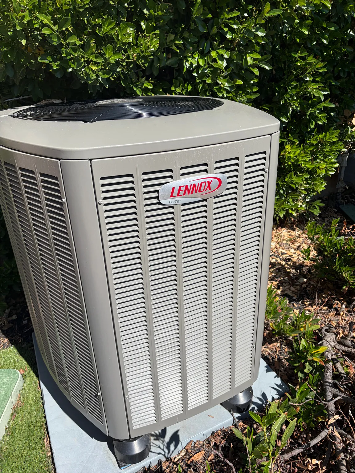 Lennox Elite exterior air conditioning unit resting on a concrete pad