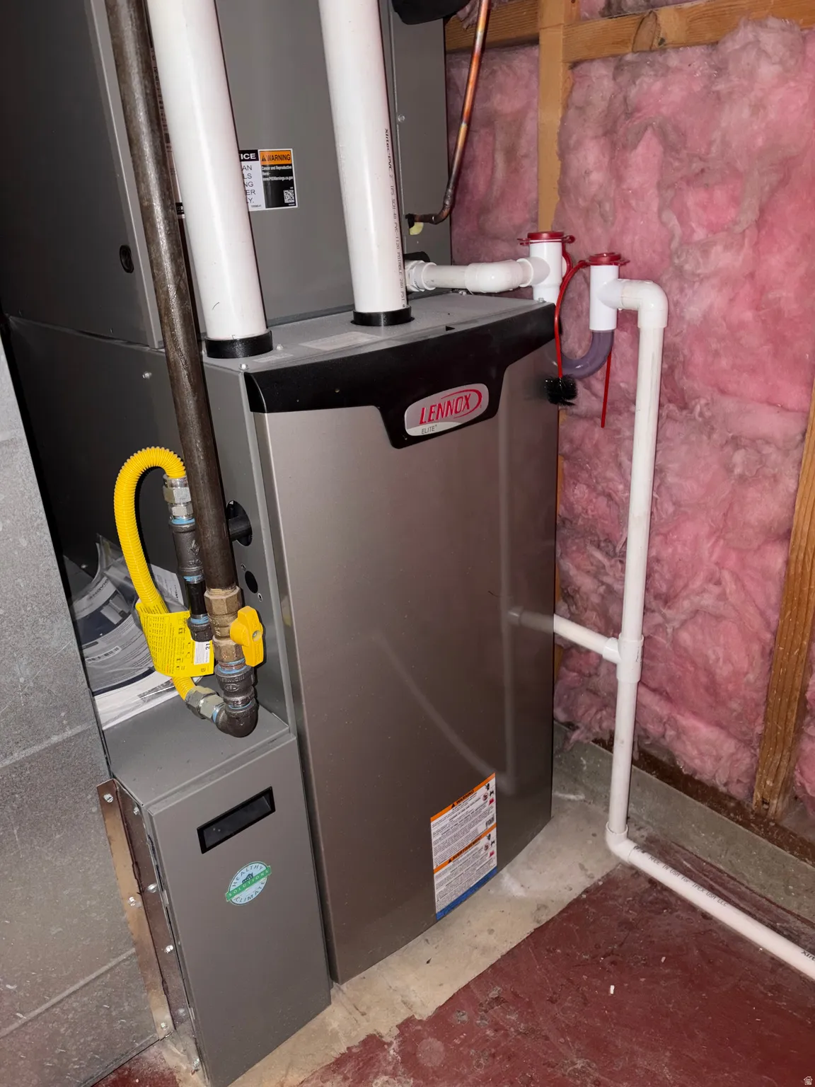 Lennox furnace unit featuring PVC piping, copper lines, and a flexible gas line connection