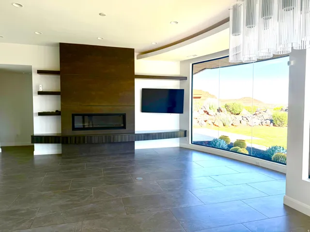 Expansive curved window overlooking desert landscaping