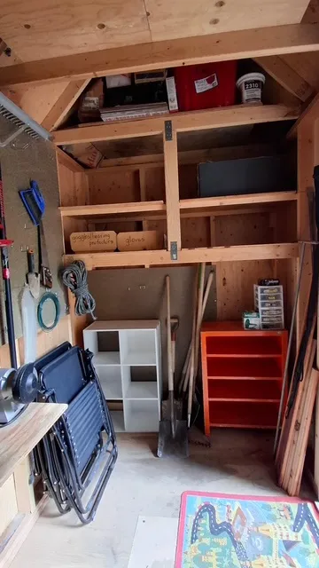 Functional shed interior featuring an open overhead storage area
