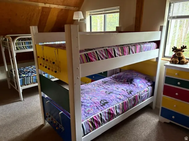 Loft bedroom with drawers, windows and second set of bunkbeds