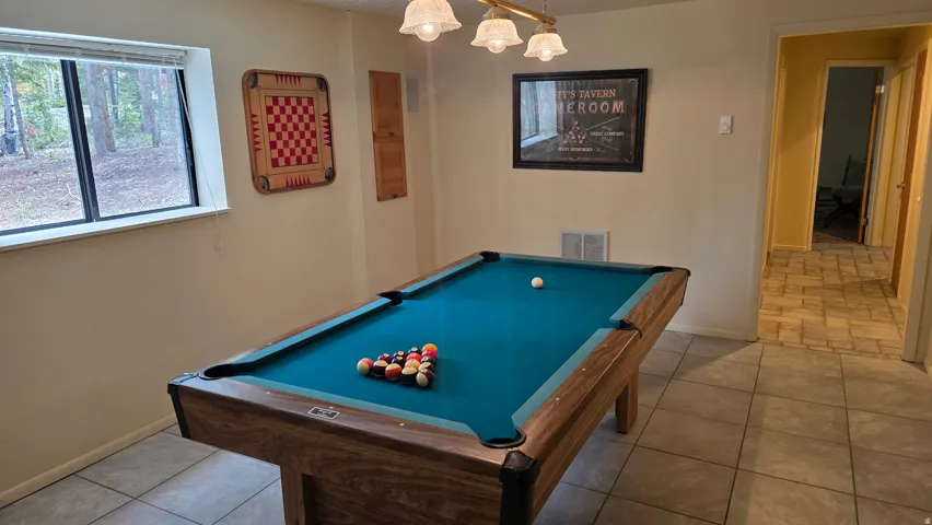 Recreation area on ground level looking to hallway to four bedrooms and a bath