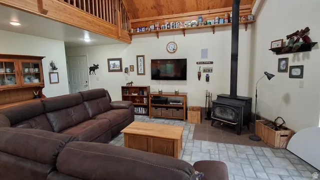 Open concept living space featuring a loft with a wood railing, vaulted wood finished ceiling and recess lighting.