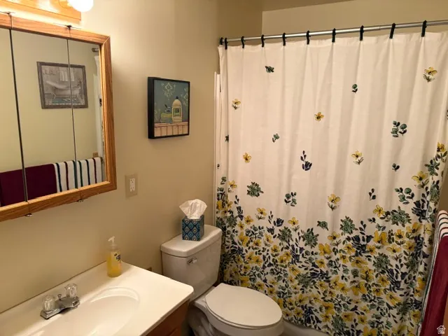 Main bath featuring a tub-shower and a vanity with an integrated sink