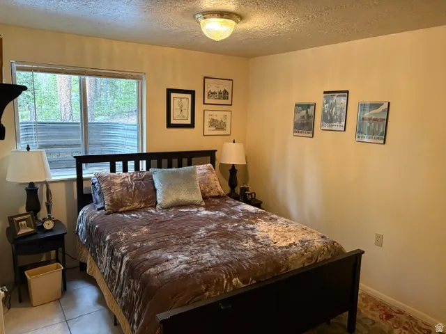 3rd bedroom down with a flush-mount ceiling light fixture and large window