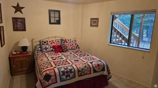 Ground level bedroom with tile flooring