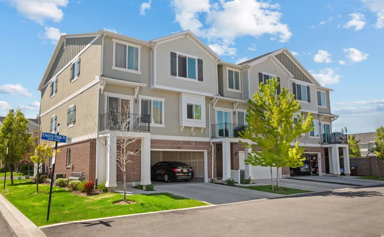 Modern townhome exterior featuring multi-level architecture with brick and siding facades