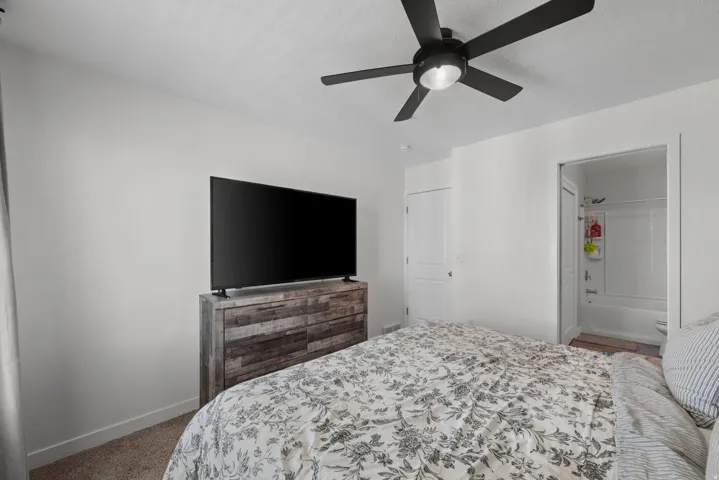 Bedroom with neutral wall paint and carpet flooring