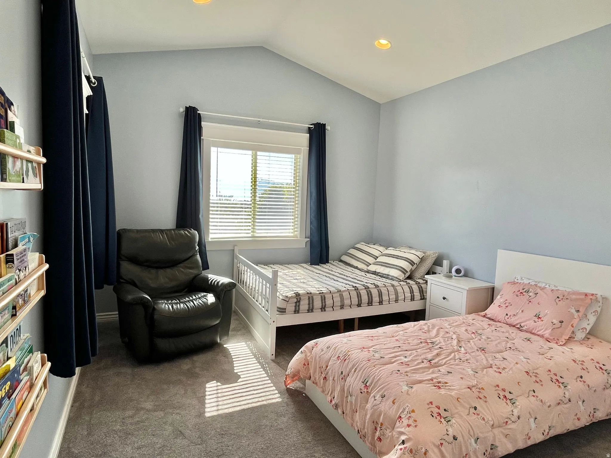 Room with vaulted ceiling, recessed lighting, and light blue wall finish