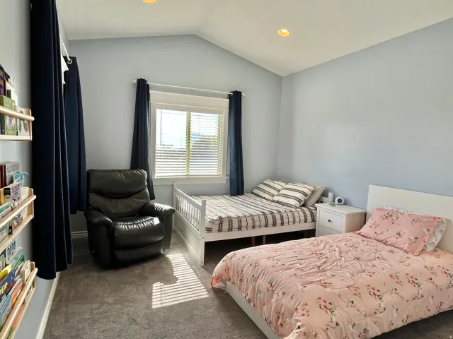 Room with vaulted ceiling, recessed lighting, and light blue wall finish