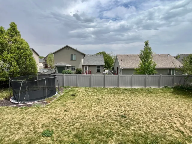 Expansive backyard area with a privacy fence