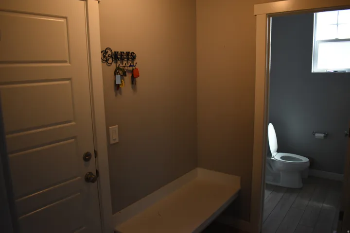 Utility area with built-in bench seating and a paneled entry door