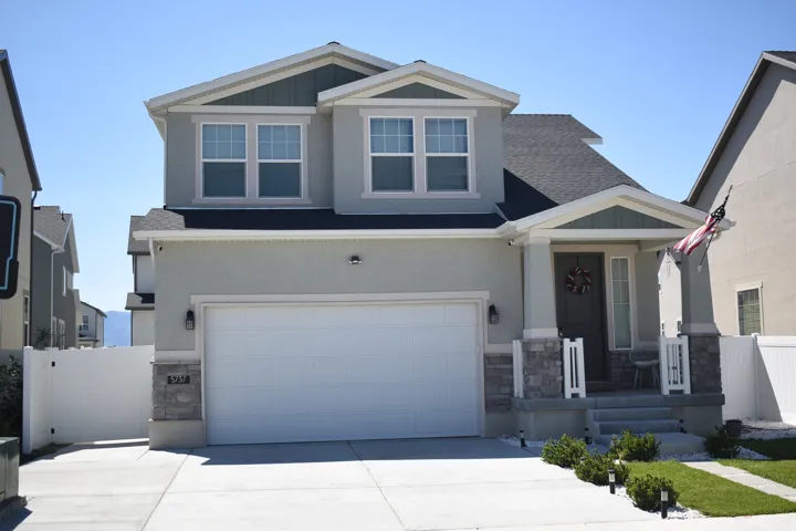 Contemporary two-story residence featuring a two-car garage with an automatic door