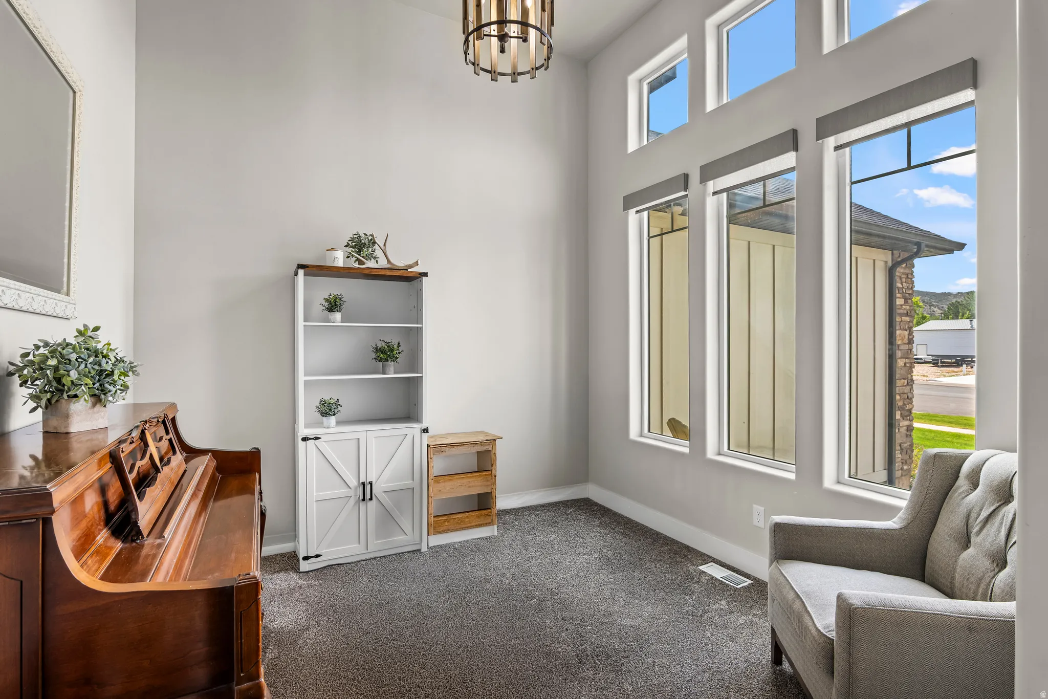 Soaring ceilings with transom windows and a contemporary chandelier