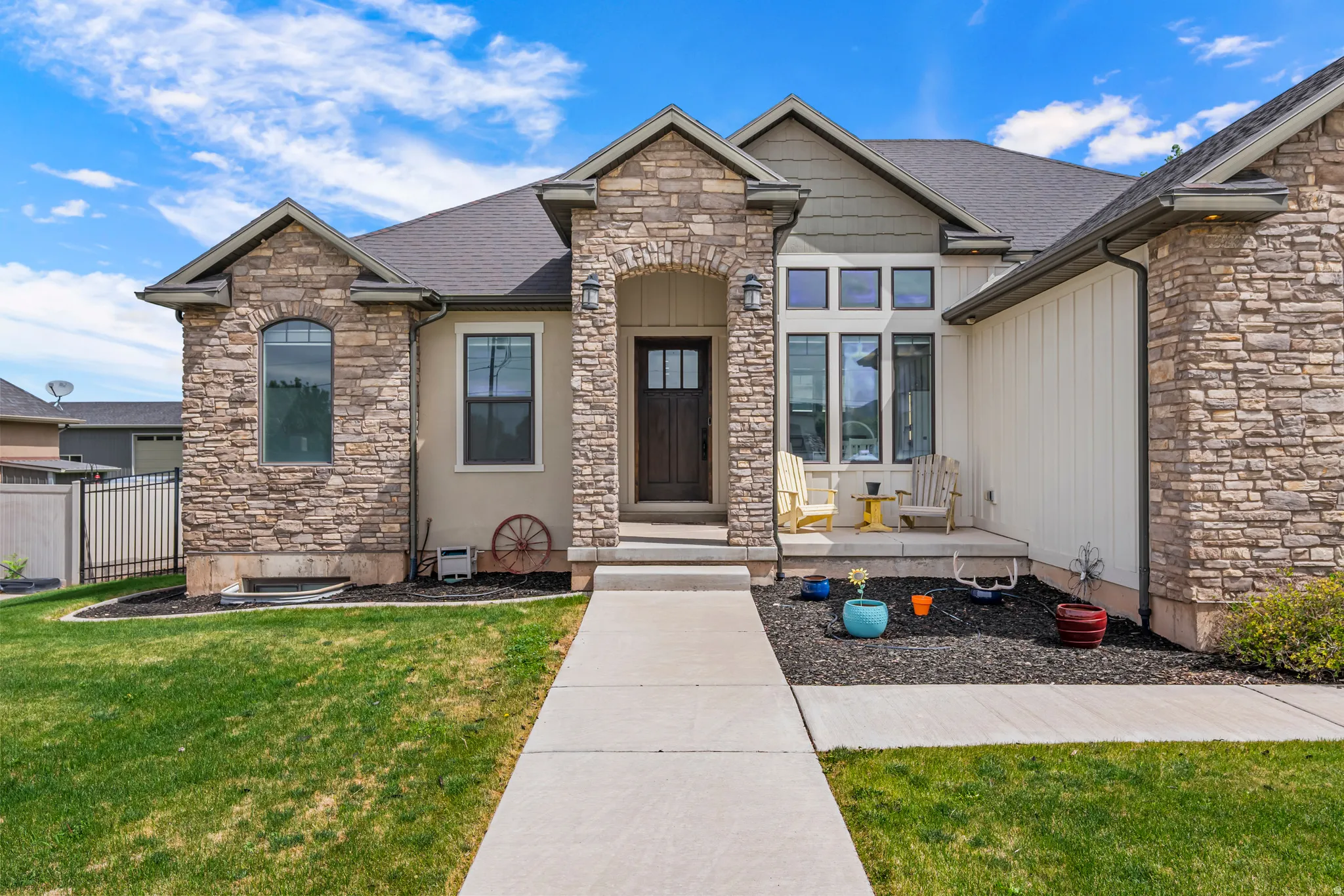 Stone and stucco exterior with a prominent arched entry