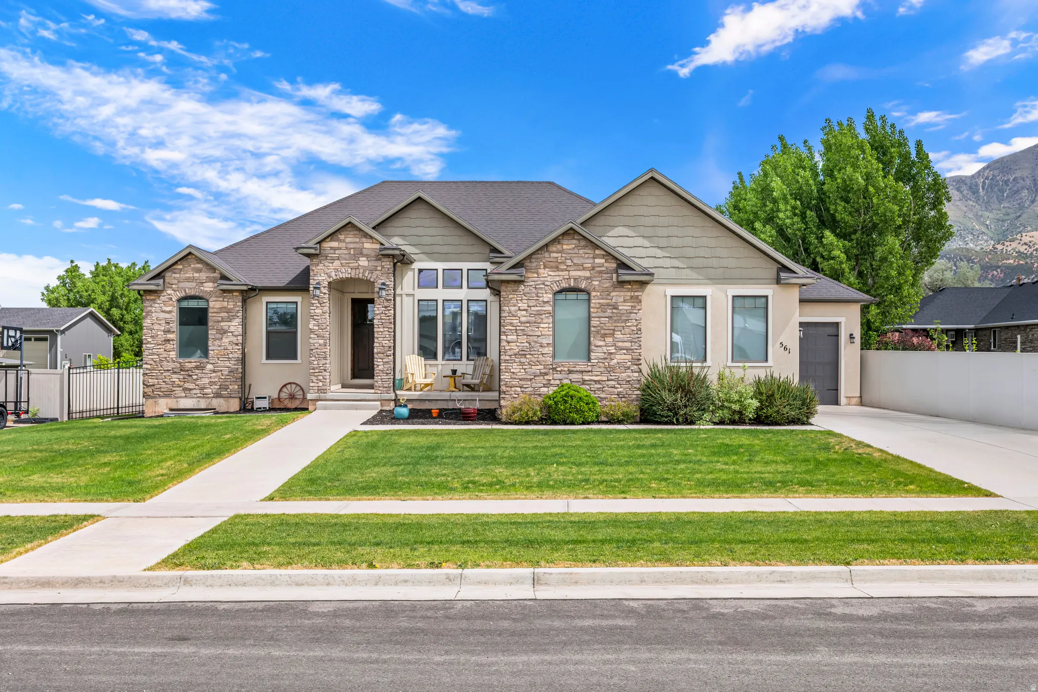 Stone veneer and stucco exterior with gabled roof lines