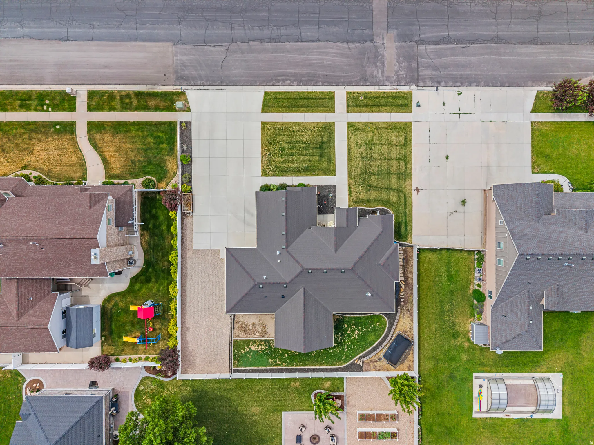 New construction residence featuring a multi-gabled roofline, concrete driveway, and paver stone patio
