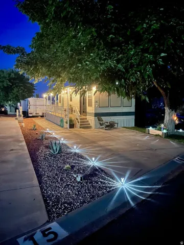 Single-story property with a covered porch and string lighting