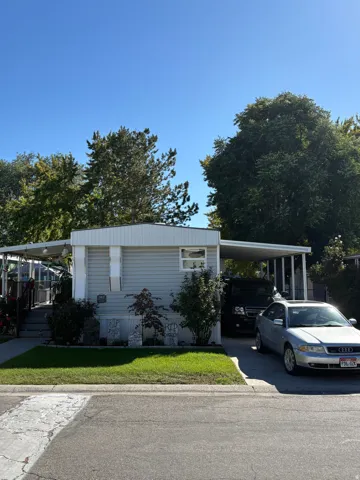 Single-story residence featuring light blue horizontal siding and a white trim