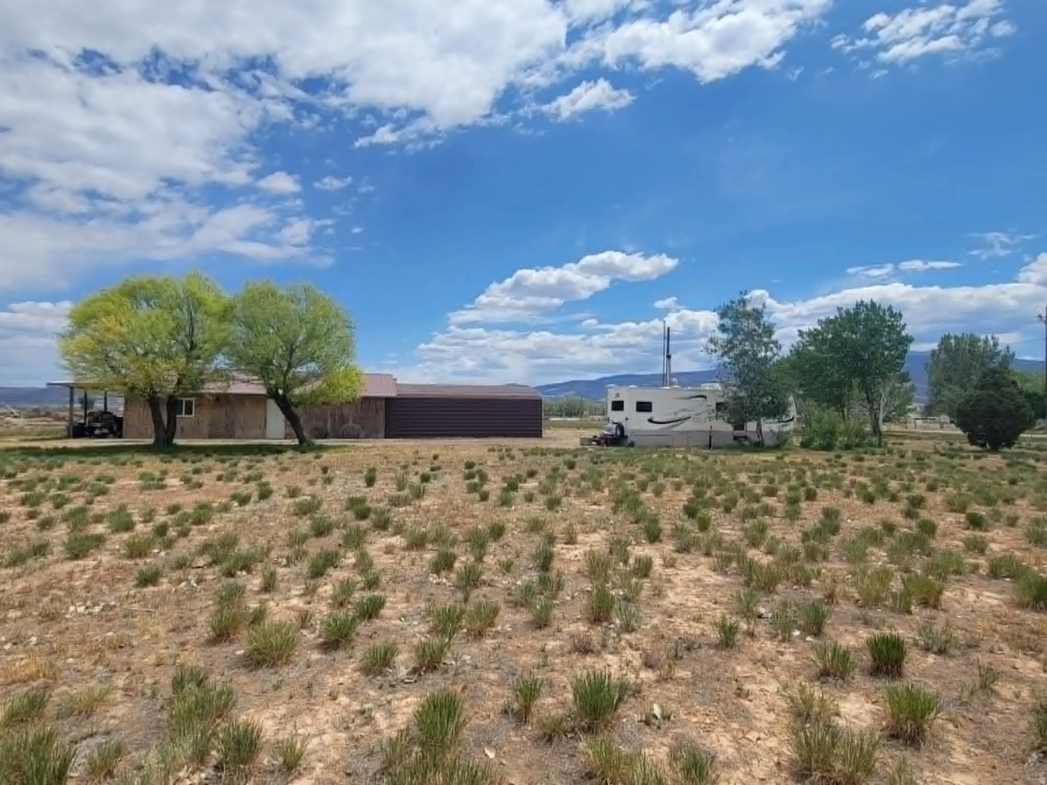Expansive undeveloped land featuring sparse native vegetation