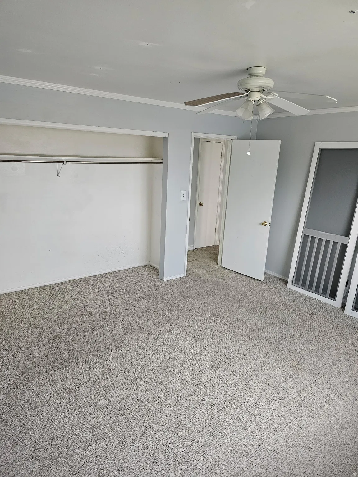 Light gray wall paint, white trim, and light gray carpeting define this interior space