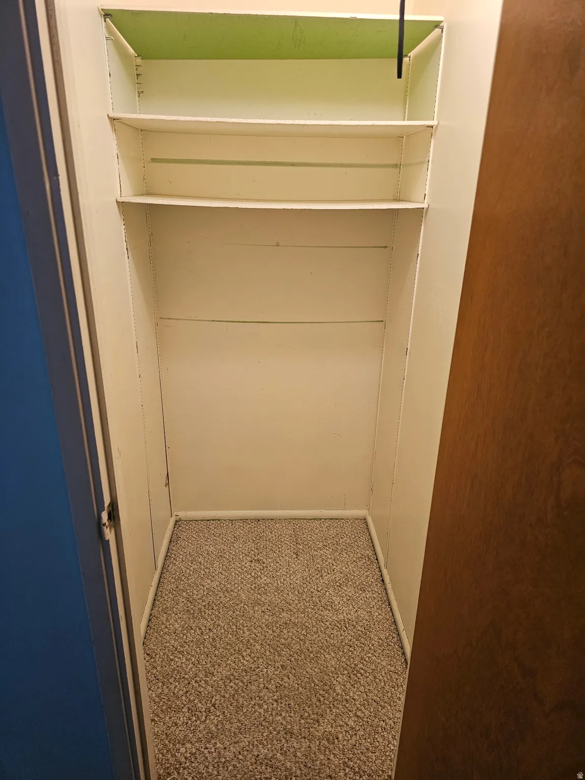 Built-in closet shelving with three levels of storage