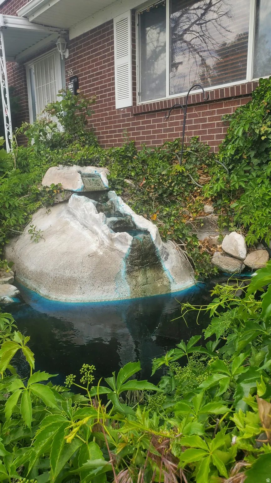 Water feature with rock-like detailing and surrounding landscaping